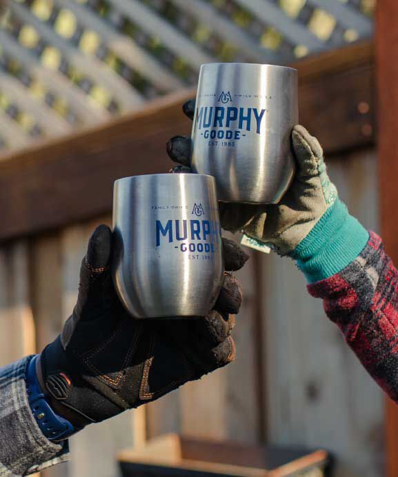 two gloved hands cheersing with Murphy-Goode wine glasses with wine